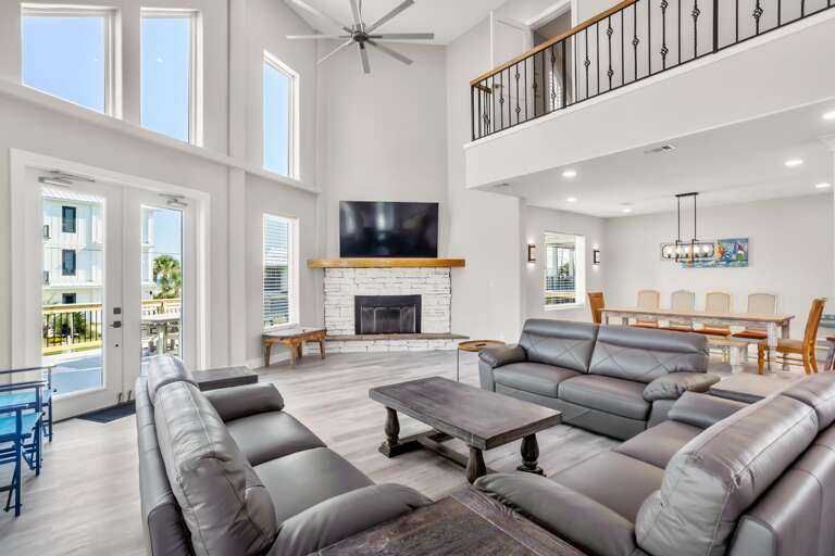 Interior Living Space With Sofas, Fireplace, And Kitchen Area Interior Living Space With Sofas, Fireplace, And Kitchen Area