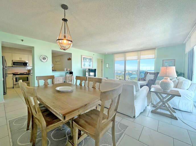Interior Dining Area With Table, Chairs, Kitchen, And Sea View