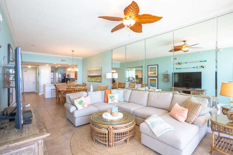 Beach-themed Living Room With Sectional Sofa And Ceiling Fans
