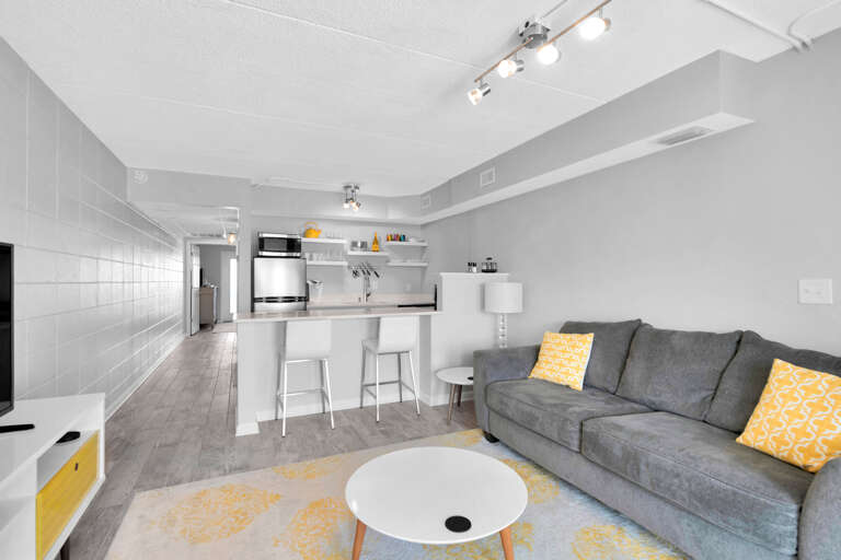 Spacious Living Room Leading To Sleek Kitchen In Light-filled Vacation Rental