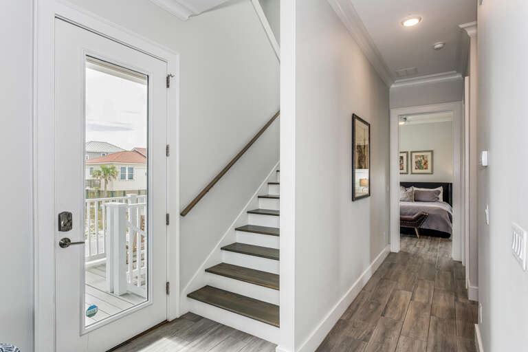 Interior Hallway With Staircase And Bedroom Entrance
