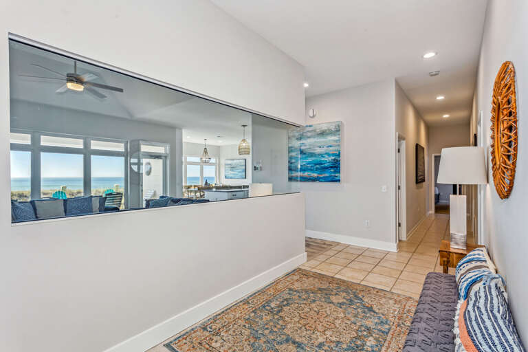 Bright Beachside Vacation Rental Interior With Hallway View Leading To Living Area