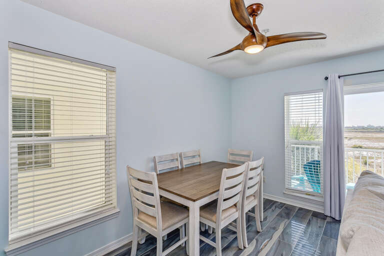 Dining Area With Table, Chairs, Ceiling Fan And Balcony Access