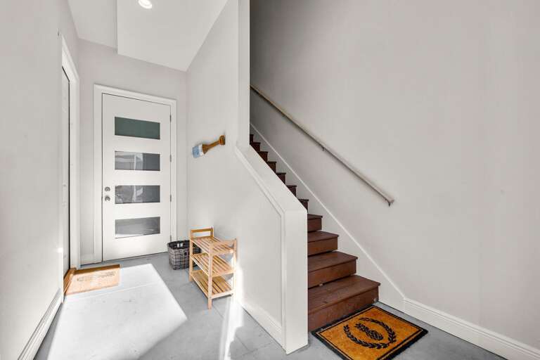 Interior Entrance With Staircase And Door