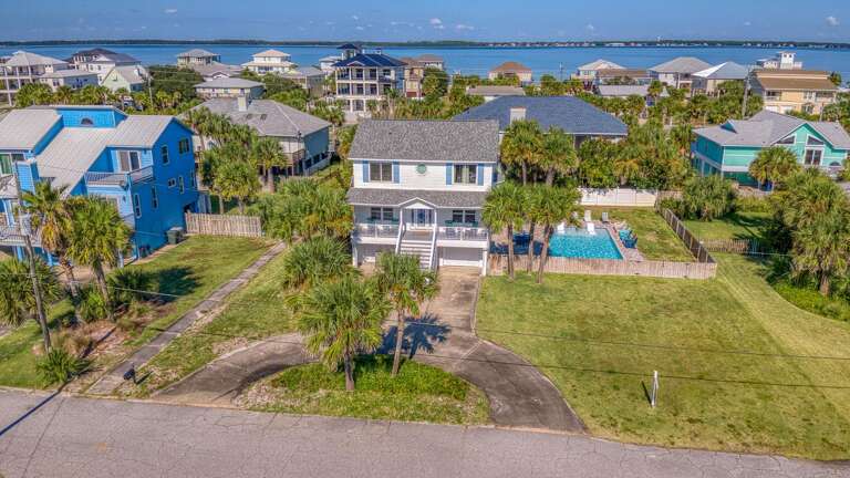 Seaside Structure Surrounded By Green, Under A Blue Sky