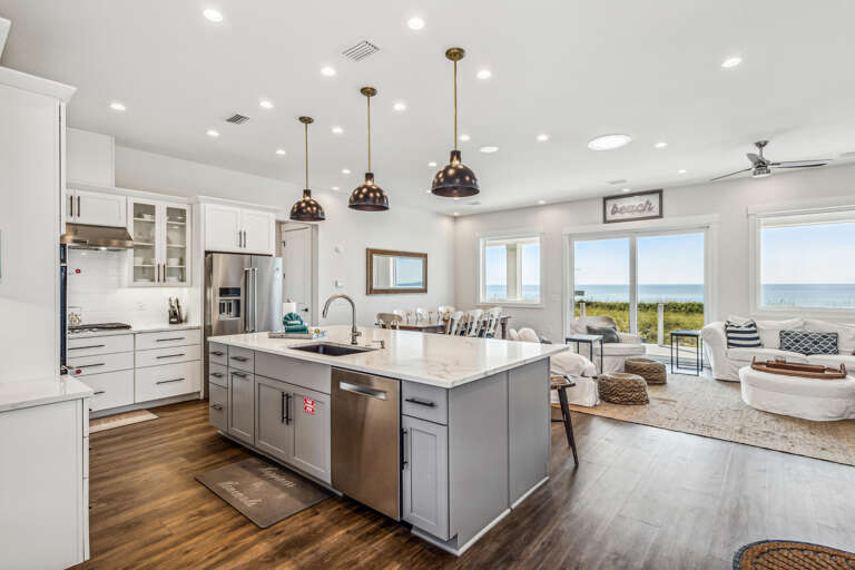 Spacious Seaside Kitchen With Sleek Surfaces, Ocean Views Through Broad Windows
