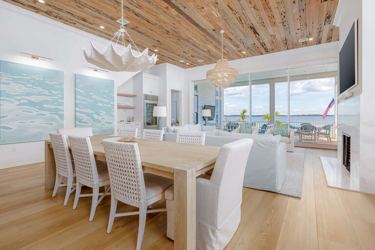 Spacious Seaside Space With Wooden Beams And White Furniture