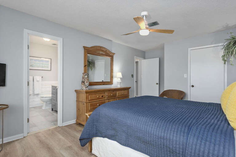 Interior Of A Bedroom With Blue Bedding And Wooden Furniture Interior Of A Bedroom With Blue Bedding And Wooden Furniture
