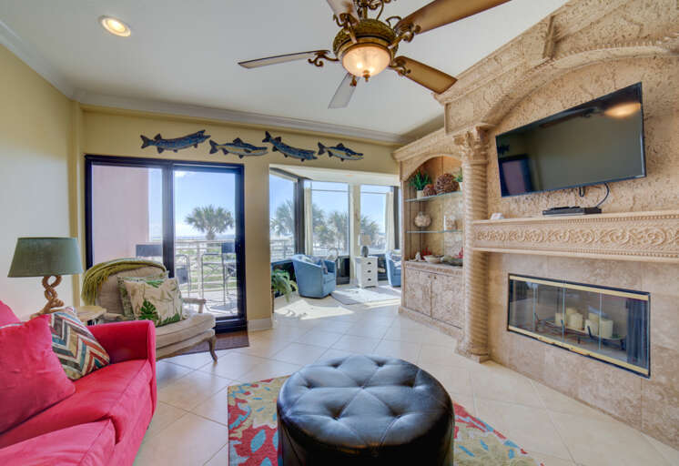 Living Room Interior With Red Sofa, Fireplace, And Sliding Door To Balcony