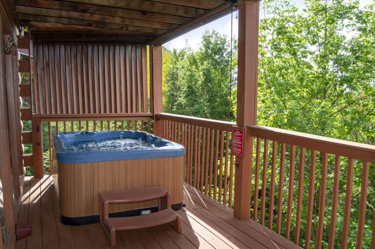 Outdoor Spa On A Timber Terrace Surrounded By Lush Leaves