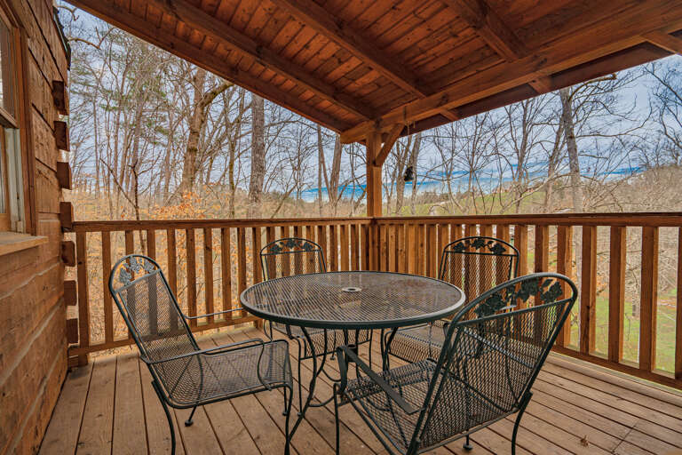 Rustic Wooden Deck Of A Vacation Rental Overlooking A Tranquil Lake