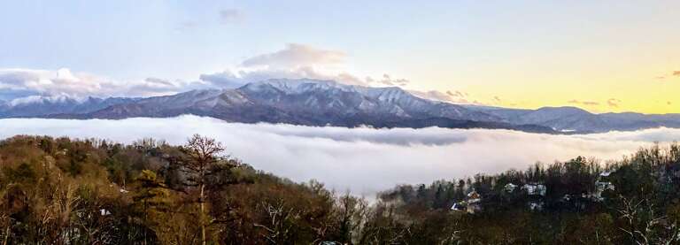 Panoramic Mountainous Vista Veiled With Vibrant Valley Fog