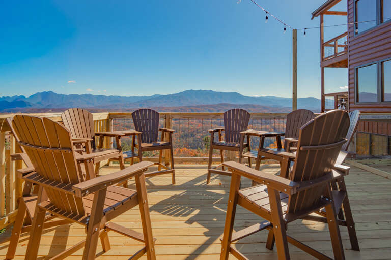 Wooden Chairs Facing Mountains From Sunny Deck