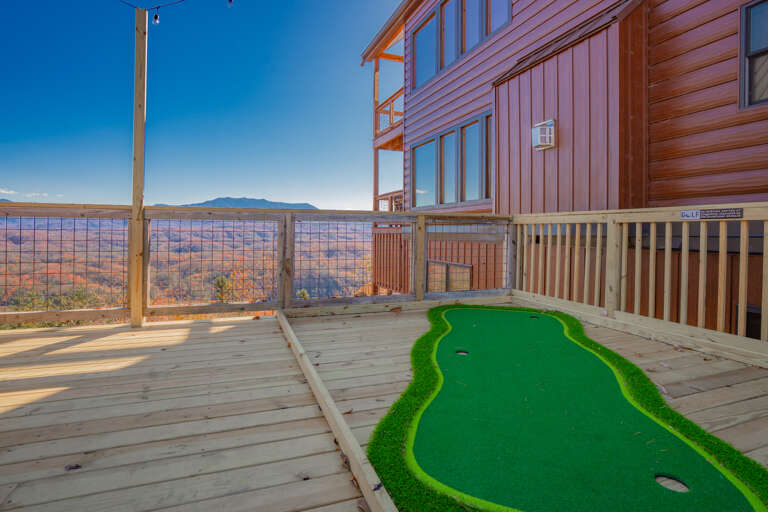 Wooden Deck With Putting Green Beside Large Cabin, Overlooking Vast Valley