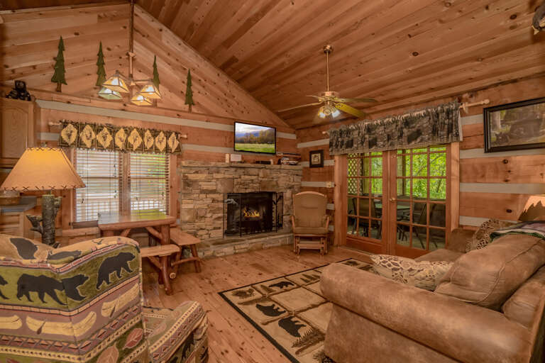 Rustic Room, Wood-paneled Walls, Stone Hearth, Mounted TV, Patterned Furnishings