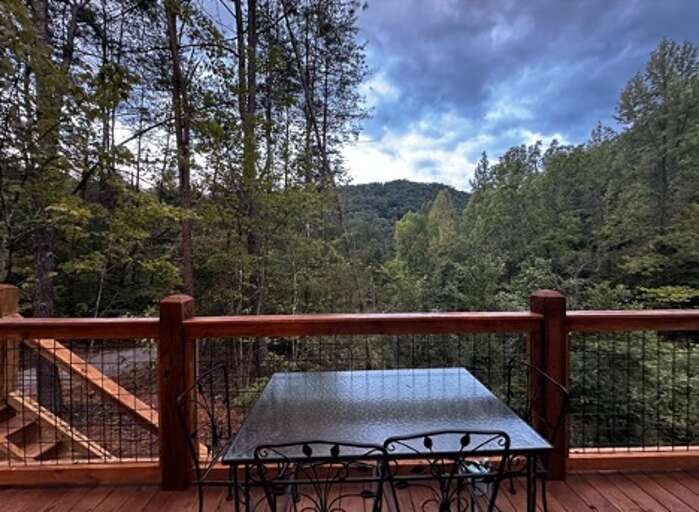 Balcony View Of Verdant Valley With A Table Set
