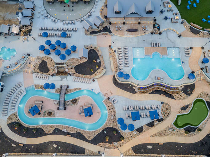 Aerial View Of A Pool Paradise At A Vacation Rental, Showcasing Sinuous Shapes And Serene Shades