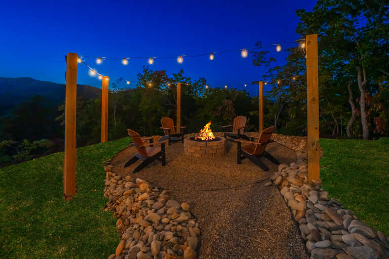 Evening Enclave: Pebble Path, Hillside Horizon, Chairs Circling Fire, Festoon Lights Floating