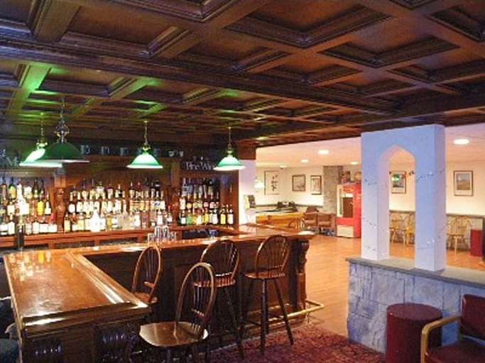 Mahogany bar and game room with stone wall Mahogany bar and game room with stone wall