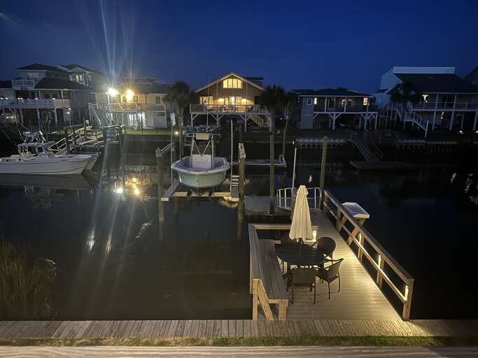 Dock with table & chairs at night from deck