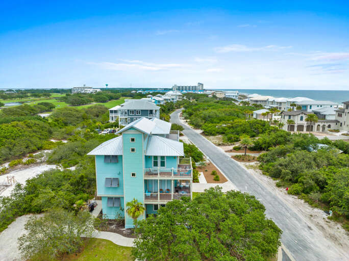 Aerial View Of Pastel Blue Building By Beachside Boulevard