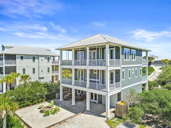 Beachside Building With Balconies, Surrounded By Greenery