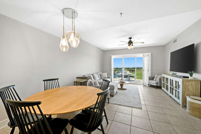 Spacious Living Space With Sleek Seating And Sliding Doors To Serene View