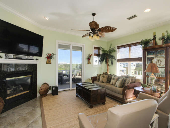 Breezy Bright Living Room With Balcony Access, Beige Sofa, And Fireplace