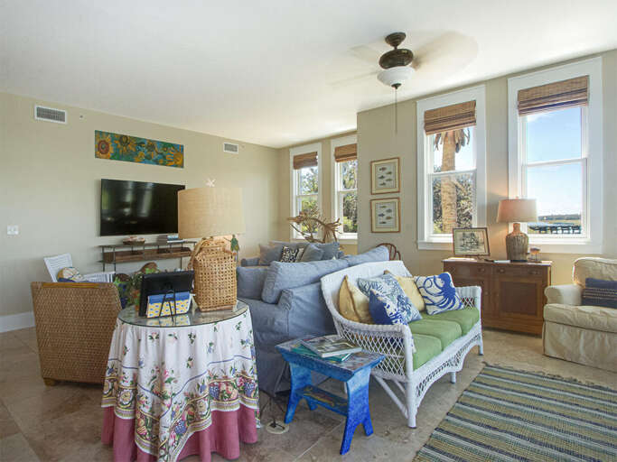 Breezy Beige Living Space With Plush Pillows And Seaside Scenery Through Windows
