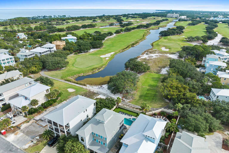 Aerial View Of Blue Buildings Beside Bending Waters And Green Spaces