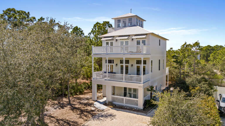 White Building, Tree-surrounded, Sunlit Setting