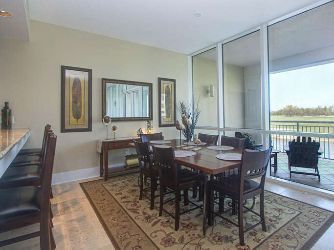 Spacious Dining Space Leading To A Scenic Balcony View In A Vacation Rental