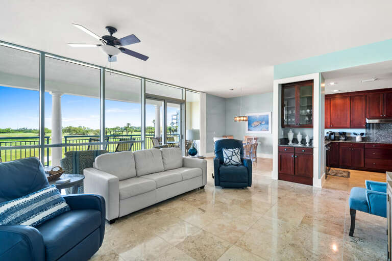 Spacious Interior Showcasing Sleek Sofas, Shiny Surfaces, And Serene Scenery