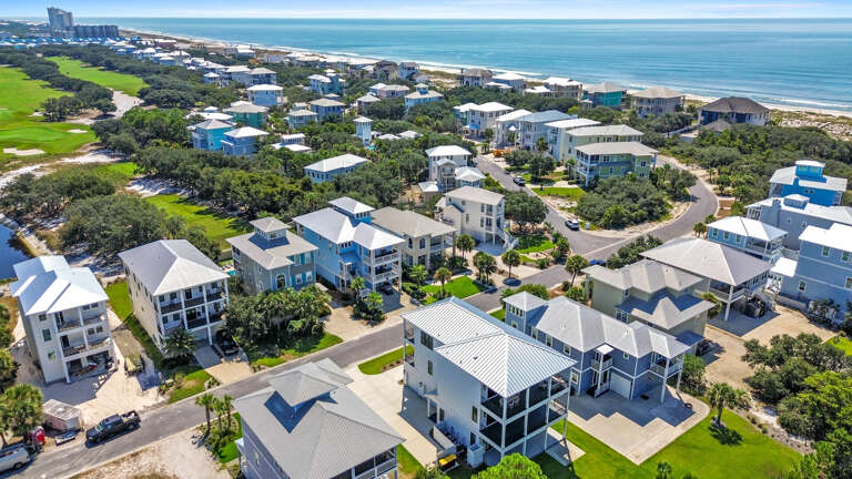 Aerial View Of Coastal Community, Clustered Homes Near Beach