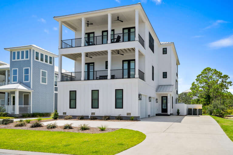 Three-tiered White Building With Balconies, Under Blue Skies