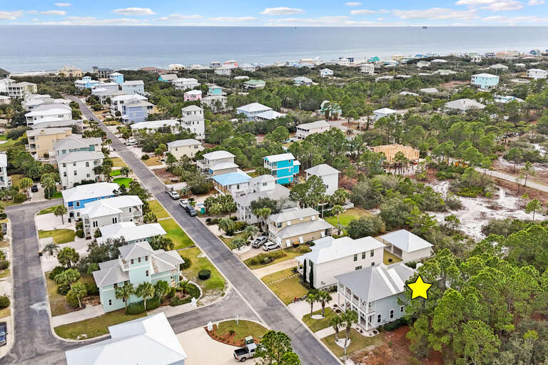 Aerial View Showing Streets And Structures Near The Sea, Highlighted Vacation Rental Marked With A Star