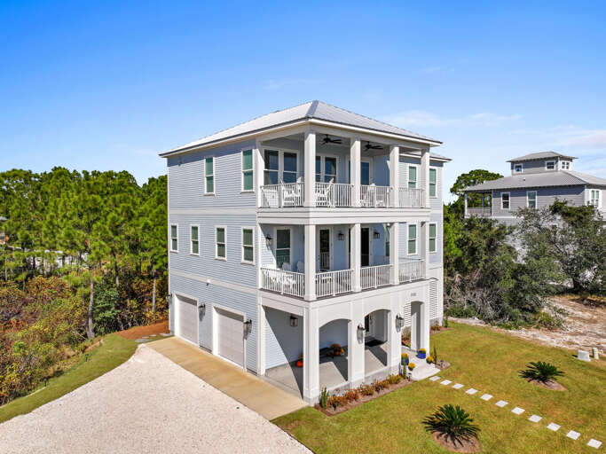 Large Three-story Residence Surrounded By Greenery With Balconies And Garage