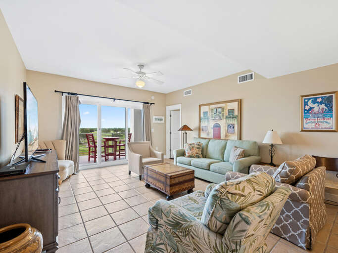 Sunlit Space With Sliding Doors, Soft Sofas, And Serene Setting In Vacation Rental