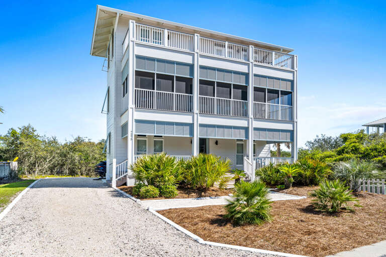 White Building With Balconies, Surrounded By Greenery