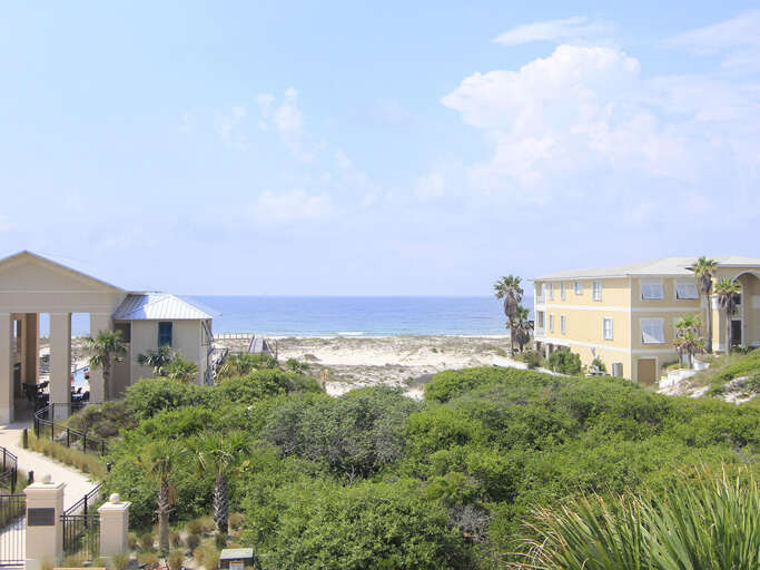 Seaside Structures And Sandy Stretch Under A Sunny Sky