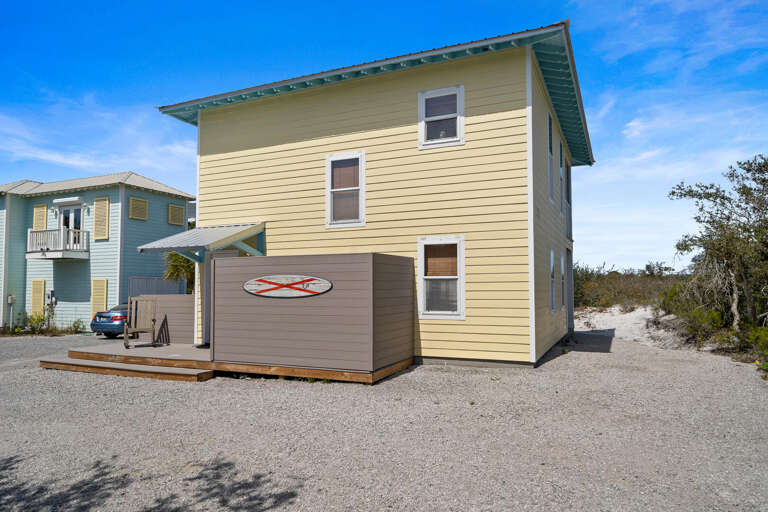 Blue And Beige Building Beside Sandy Path Under Clear Sky