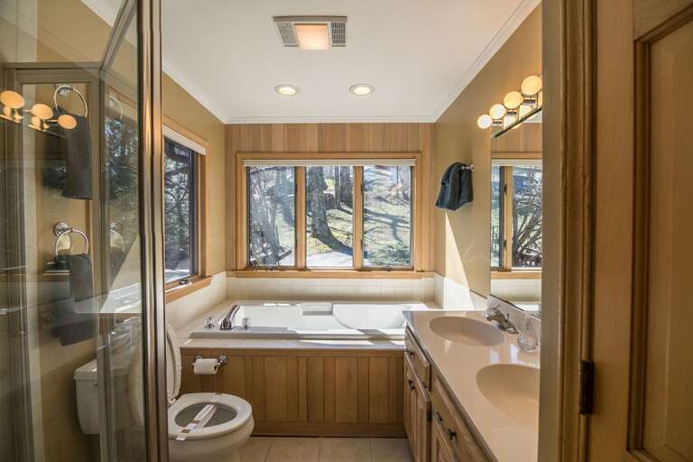 Full sized bathroom with soaking tub and shower
