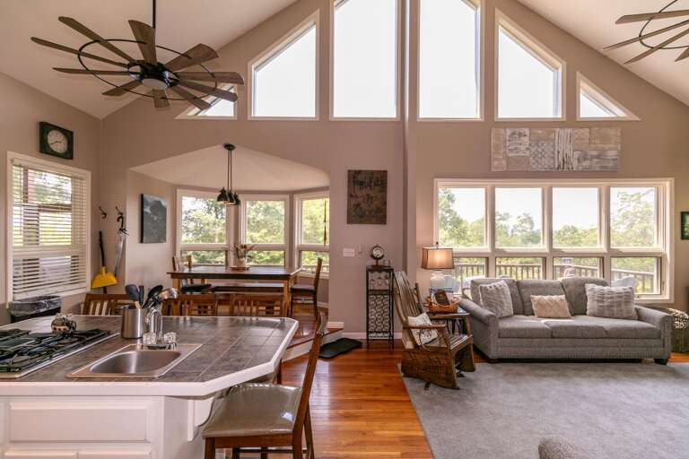 Spacious Living Room Interior With Vaulted Ceiling And Large Windows