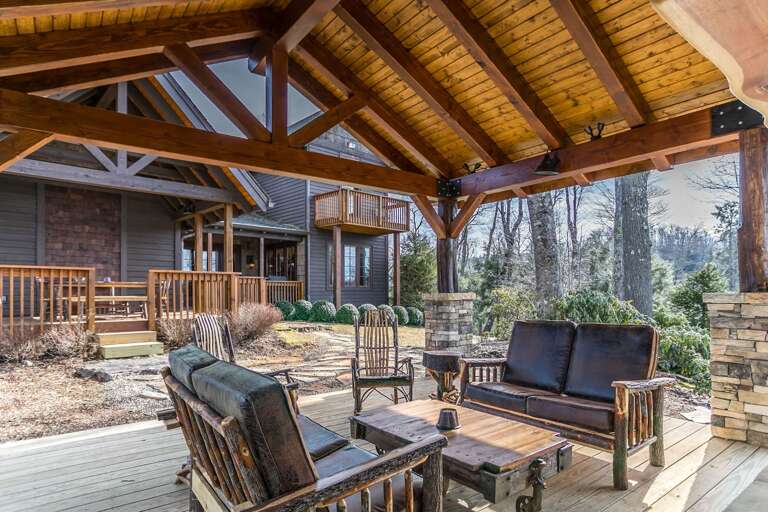 Covered deck with fireplace, TV and chairs Covered deck with fireplace, TV and chairs