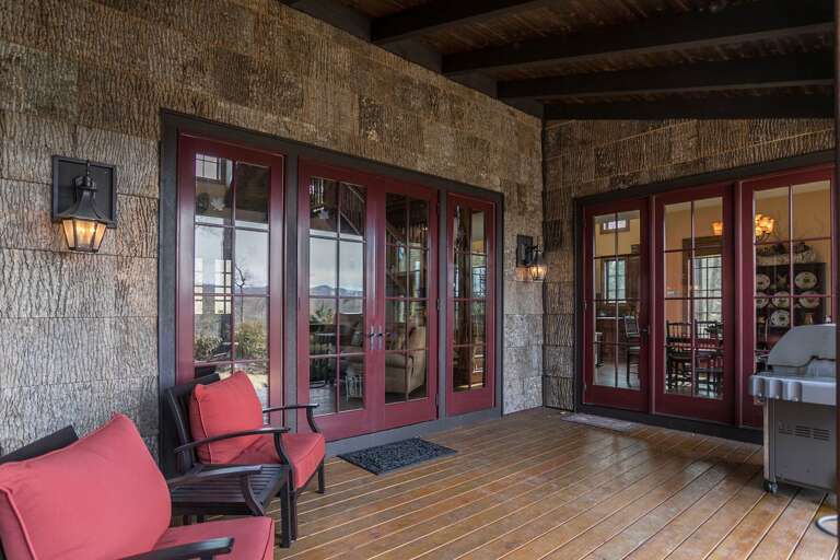 Covered deck with outdoor seating and grill