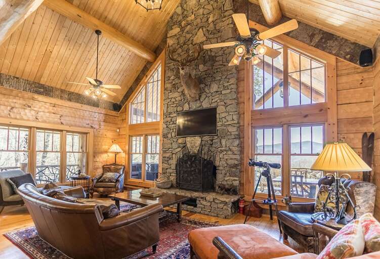 Living room with wood burning fireplace, TV and cozy furniture