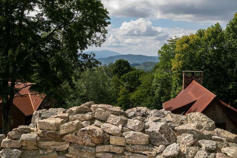 Stone Barrier Before Buildings Beneath Broad, Blue Sky