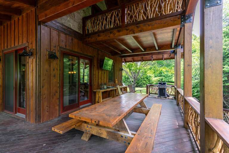 Rustic Terrace With Wooden Table And Benches At Vacation Rental