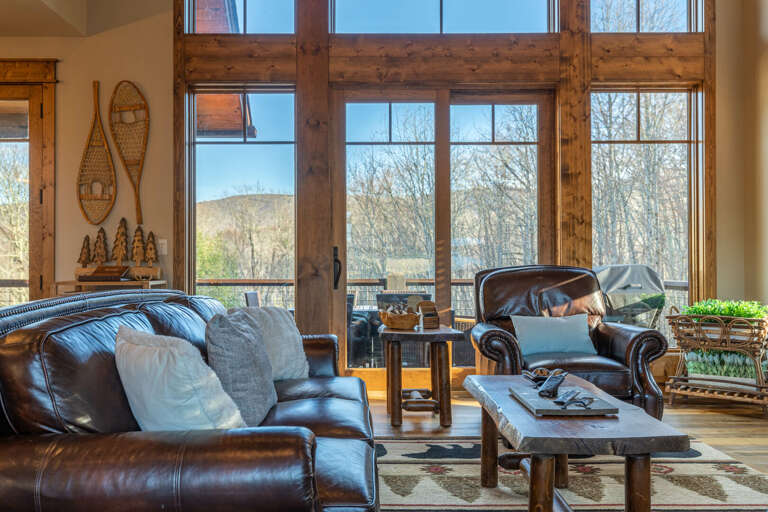 Rustic Living Room Interior With Leather Furniture And Large Windows