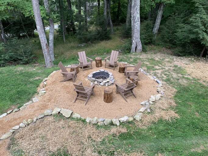 Outdoor Fire Pit With Chairs In A Wooded Area